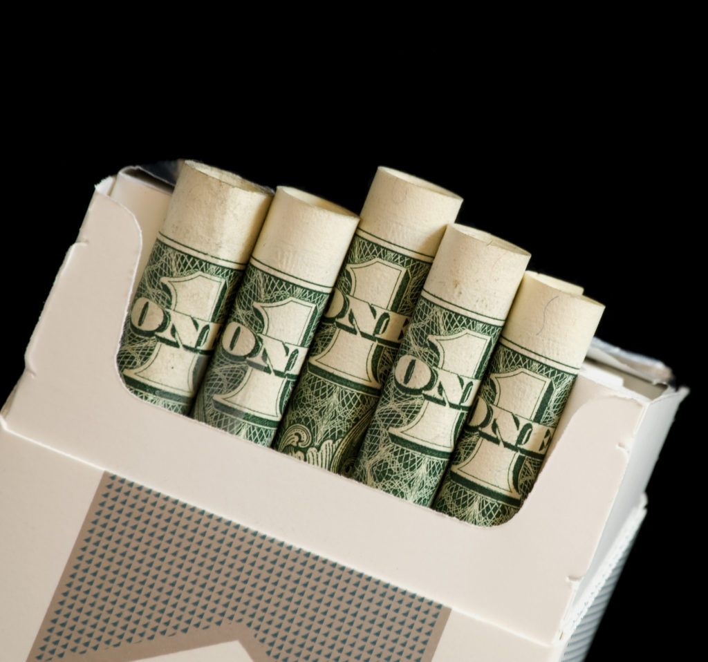 Image of a pack of one dollar bills rolled into cigarette pack